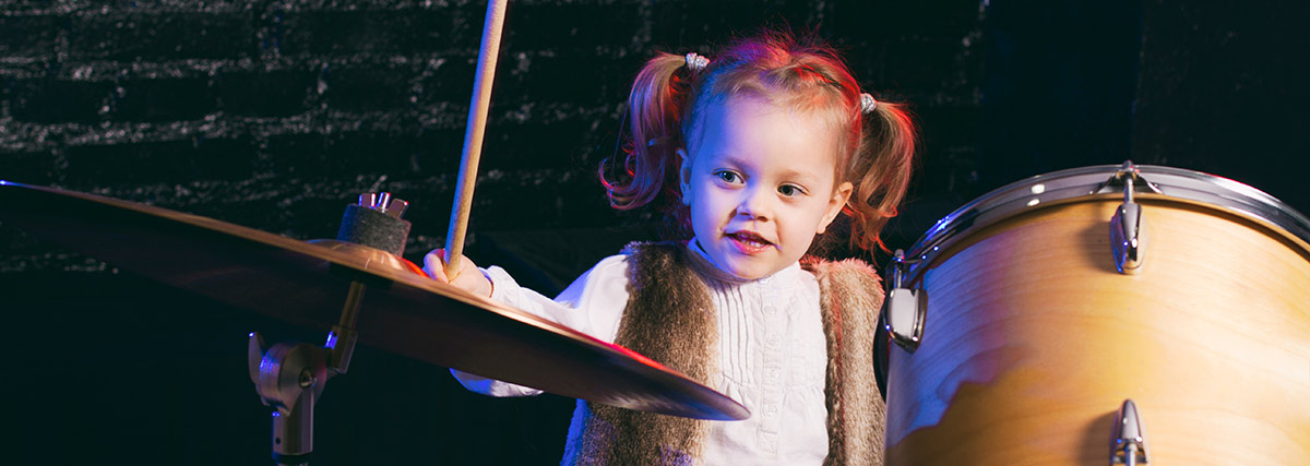 Little girl playing drums